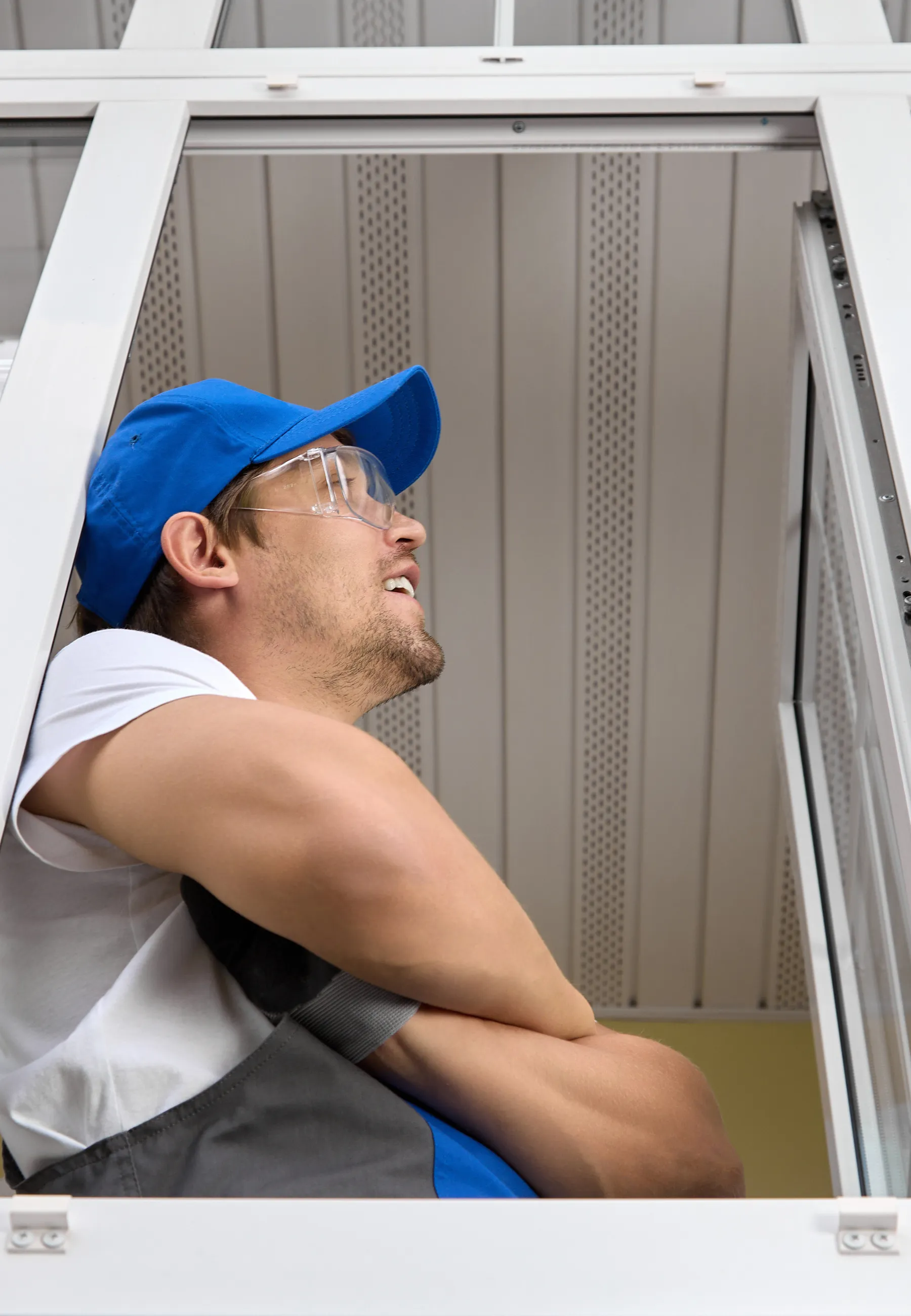 specialist reviewing a finished glass installation with satisfaction and professional pride