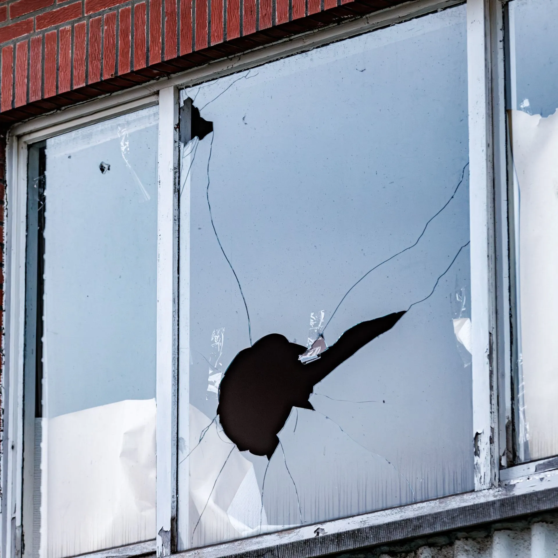 Detailed view of shattered tempered glass in a Dallas residence, ready for professional emergency board-up and replacement.  