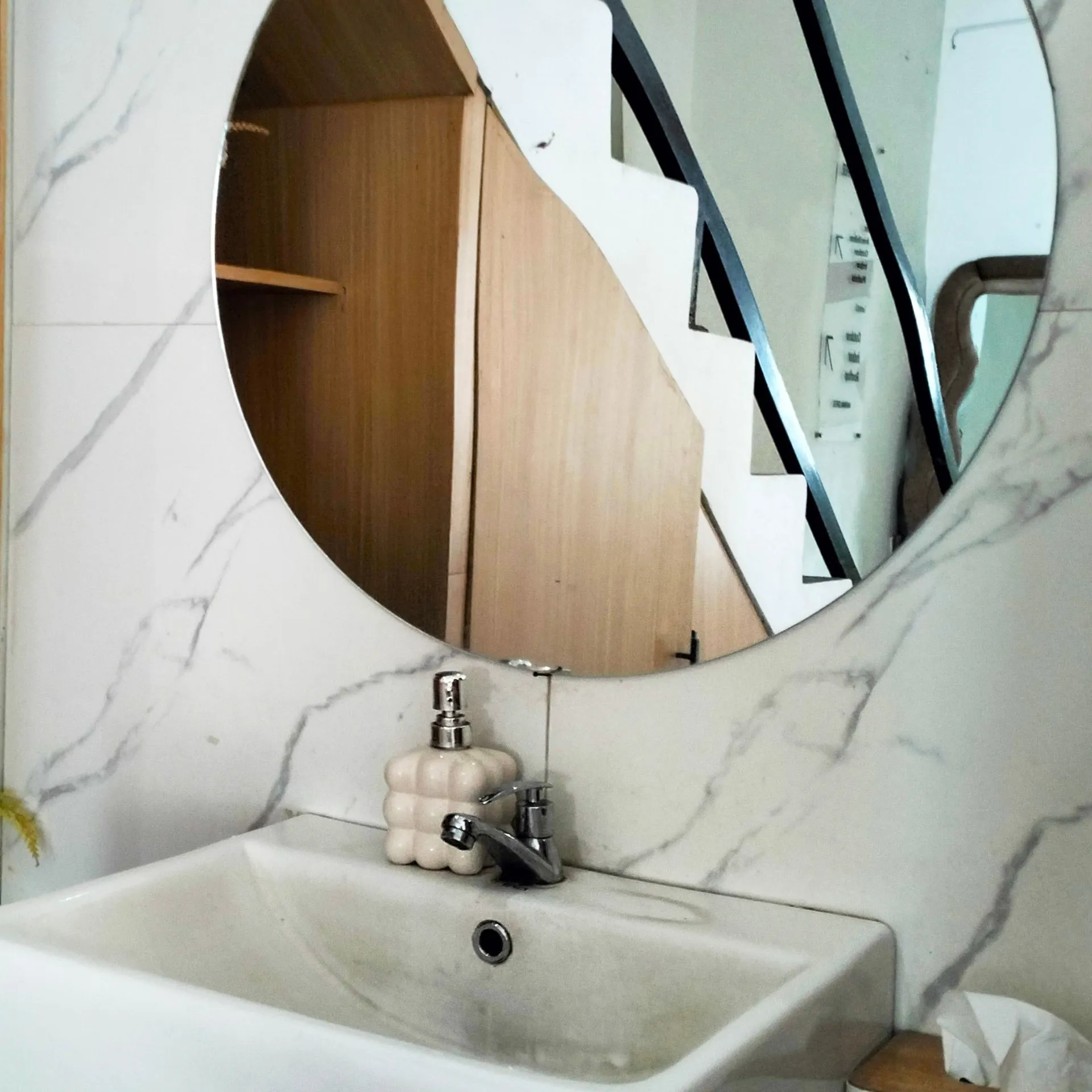 Professional glass technician installing a large custom-cut mirror in a residential bathroom in Dallas, TX.
