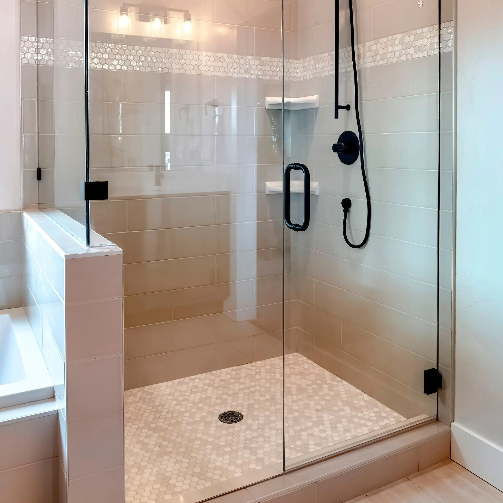 Close-up of high-quality stainless steel clamps and thick tempered glass for a frameless shower in Dallas.