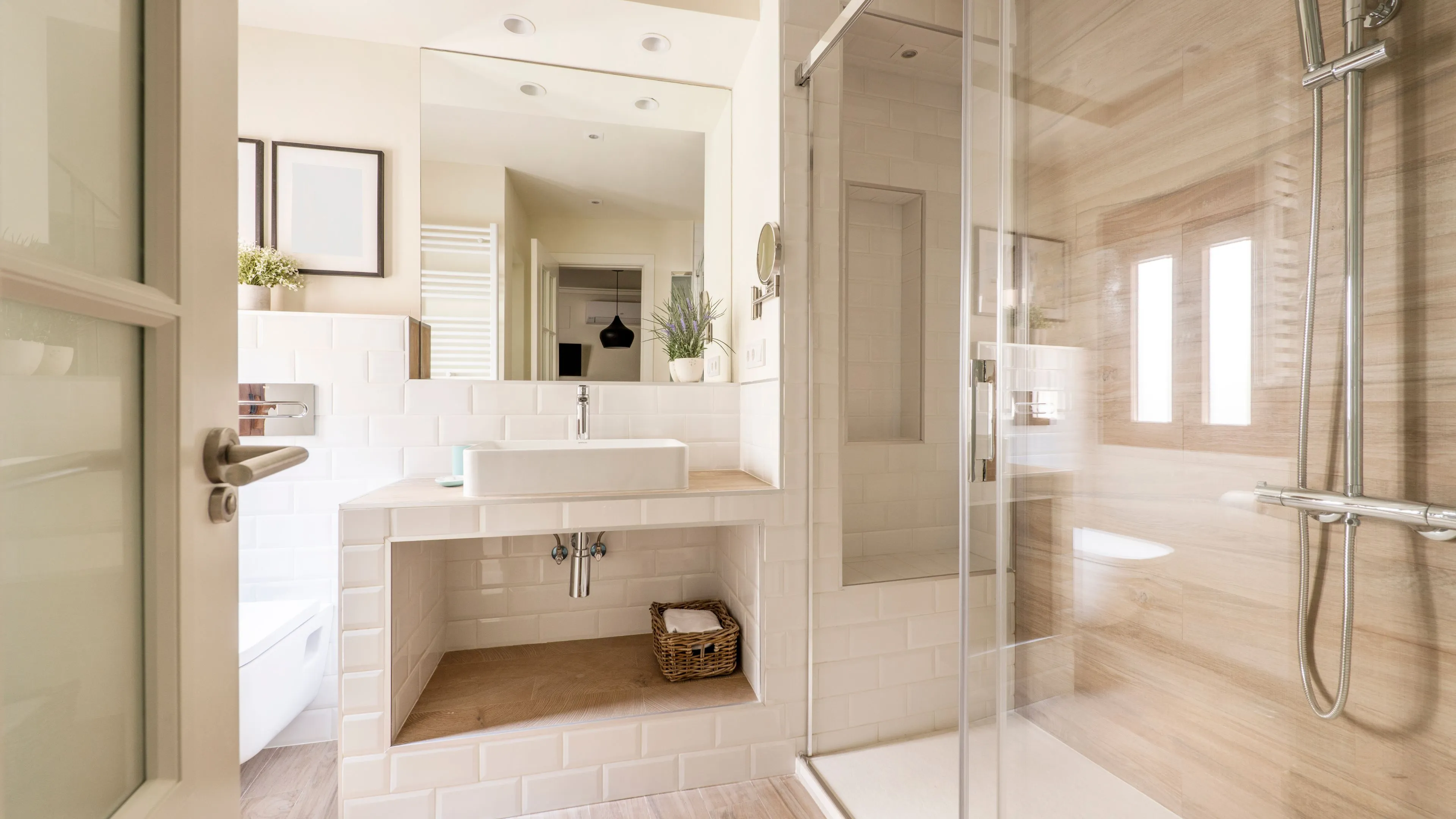Minimalist frameless shower door providing a clean, open look for a master bathroom remodel in Dallas